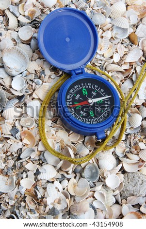 Dark blue compass on sand