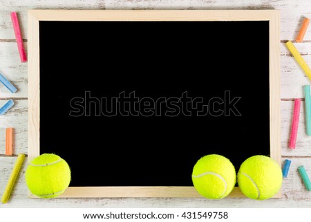 Blank blackboard and Tennis ball on wooden table.Template mock up