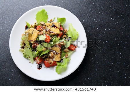vegan salad with roasted tofu, food top view