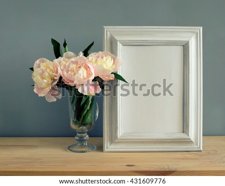 Mother's Day, Women's Day or other suitable holiday card, photo frame with blank space for a text on a table with flowers bouquet, stylized image