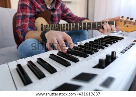 Man with guitar and synthesizer closeup