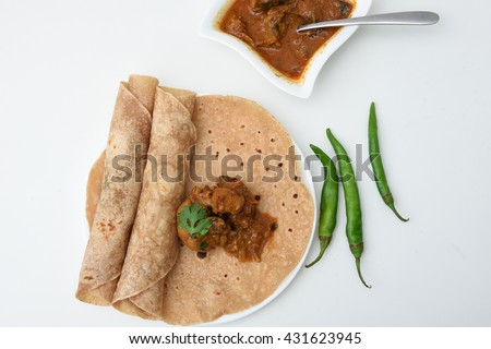 Homemade fresh chapati, chapathi, chapatti, roti or flatbread made from whole wheat flour / atta  and chicken tikka masala curry Mumbai North India. famous Indian basic food. Indian spices used