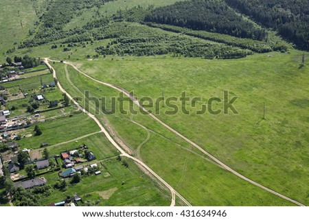 Aerial View - Russian village, meadows and fields. Shooting from the helicopter.