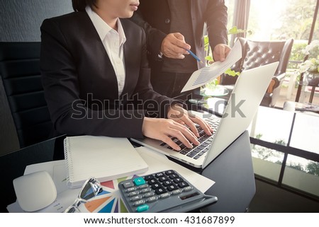 Business people discussing the document at a meeting