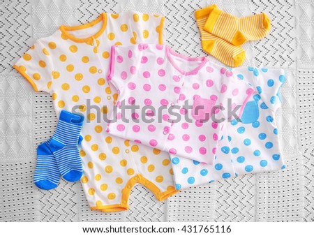 Baby clothes on fabric background
