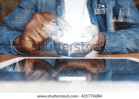 Visual effects. Graphic icons. People and future technology concept. Cropped shot of African American young man in denim jacket, touching electronic gadget with reflective touchscreen surface