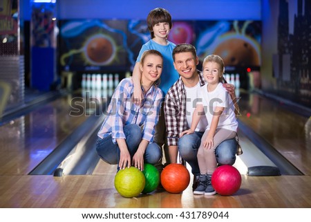 Smiling family with child in bowling