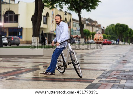young hipster man with fixed gear bike on city street