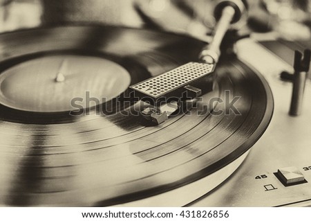 Textured retro image in sepia of vinyl record player. Royalty-Free Stock Photo #431826856