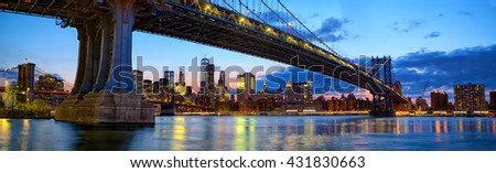 Manhattan Bridge panorama with skyline and Brooklyn Bridge at dusk, New York