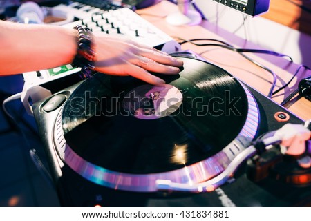 DJ creates composition in the recording studio.  DJ playing music in the recording studio. Studio record of new music track.