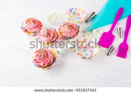 Pink homemade cupcakes  and cookware. Birthday cupcakes. Homemade cupcake. Sweet dessert pastry.  