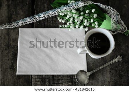 bouquet of lilies on wooden background and morning coffee
