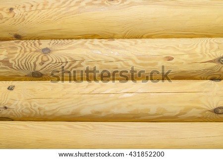 Part of the wall of logs. Log walls made of round of pine logs.

