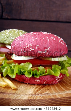 Different colors of burgers and fries