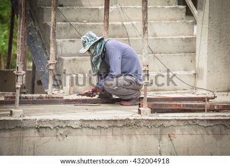 Welder man working at new building site