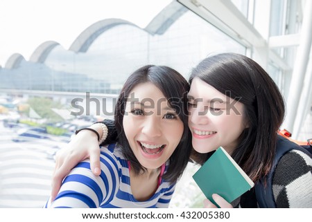 Happy group travel women hold passport and take a selfie. shot in hong kong, asian