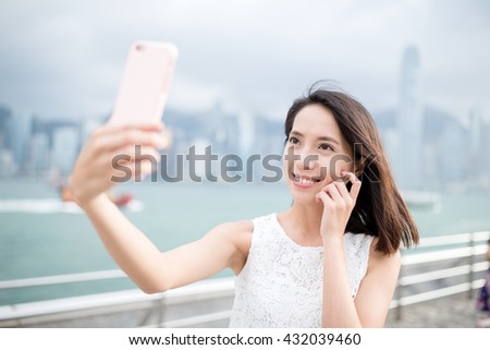 Woman taking self image by mobile phone