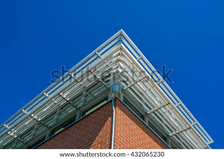 Corner of a building roof with shadowing grid above the windows.