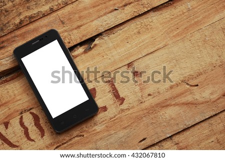 White screen cell phone on old wooden