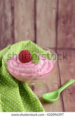 Raspberry mascarpone dessert with mint leaf

