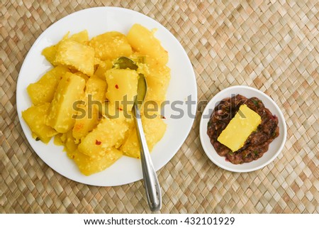 Popular traditional South Indian food cooked tapioca / cassava root / mandioca / aipim with grated coconut and chutney Kerala, India. root vegetable Brazil. served with Fish curry