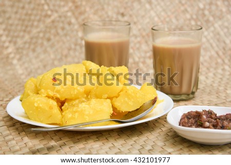 Popular traditional South Indian food cooked tapioca / cassava root / mandioca / aipim with grated coconut and chutney Kerala, India. root vegetable Brazil. served with Fish curry