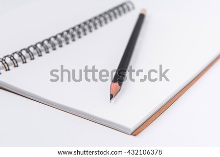 Blank Notebook with Pencil isolated on White Background.