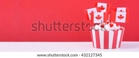 Happy Canada Day Party Cupcake with maple leaf flags on a white wood table sized to fit a popular social media cover image placeholder.