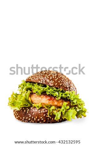 Juicy delicious burger on a bun dark on a white background