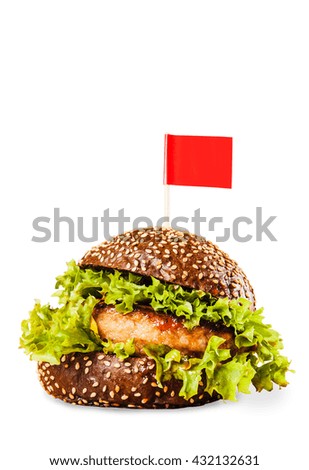Juicy delicious burger on a bun dark on a white background with a red flag