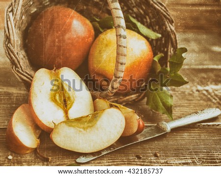 ripe apples in a basket on a wooden background. vintage and retro tone