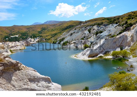 Blue Lake surrounded by white quartz cliffs. This area was mined for gold in the nineteenth century near the town of St Bathans, on the Otago Rail Trail, New Zealand