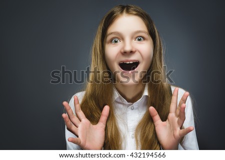 Closeup Portrait of happy girl going surprise isolated on gray background