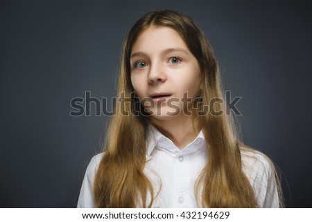 Closeup Portrait of happy girl going surprise isolated on gray background