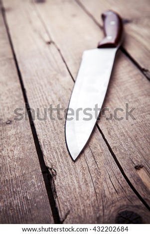 Brown knife on an old kitchen. Cooking, cutting, cooking. On wooden background