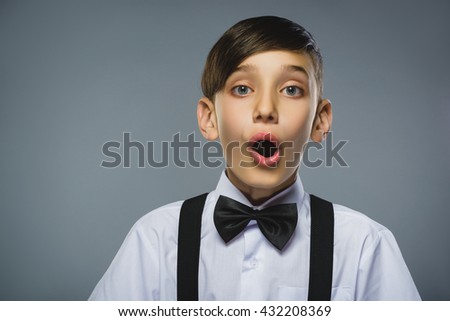 Closeup Portrait of happy boy going surprise isolated on gray background