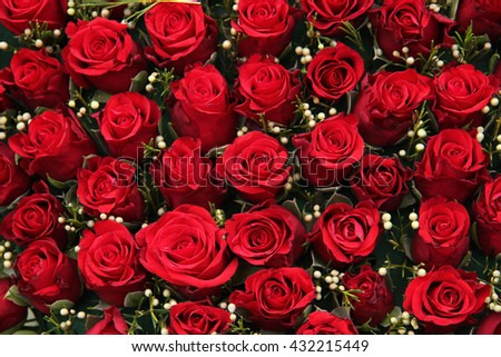 Group of red roses and small white berries, wedding decorations