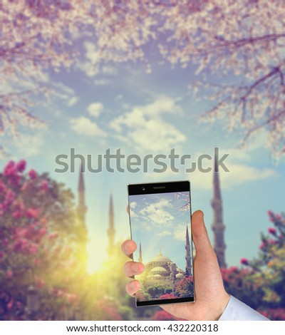 Tourist taking a picture in front of The Blue Mosque at spring,  Istanbul, Turkey. Travel concept 