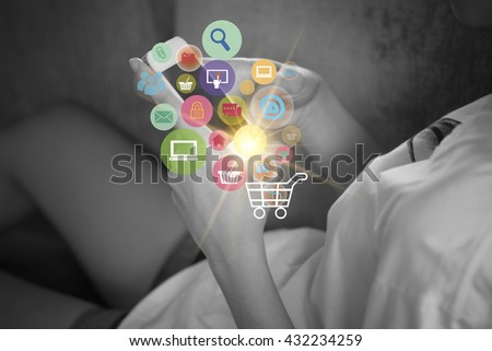Young woman are using shopping cart with application software icons as business shopping online concept , black and white background image