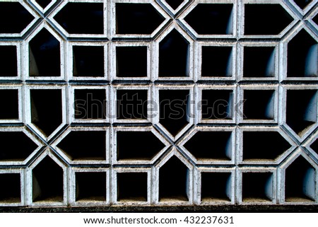 Dark background consisting of black pentagons and squares on white contours. Photography can be used for creating textures, graphics editors, postcards. invitations and unique design