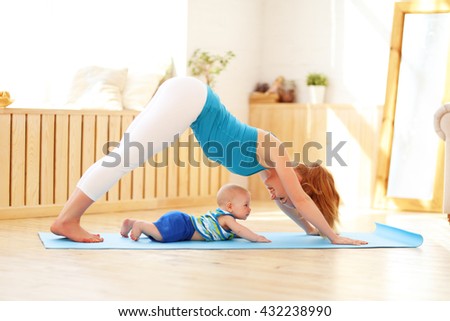 sports mother is engaged in fitness and yoga with a baby at home  Royalty-Free Stock Photo #432238990