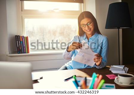 Business woman getting ready to mail a letter looking satisfied Royalty-Free Stock Photo #432246319