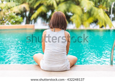 women relaxing at poolside indoor swimming 
