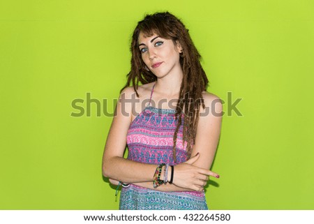 Girl with dreadlocks posing over colorful background