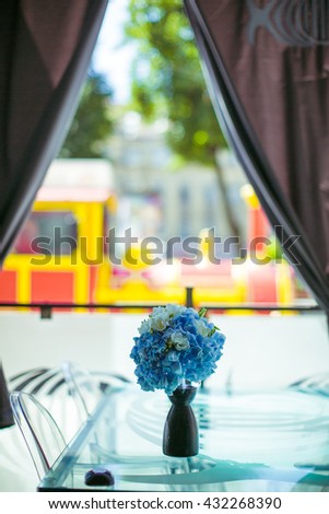 beautiful bouquet of white and blue flowers stands on a table