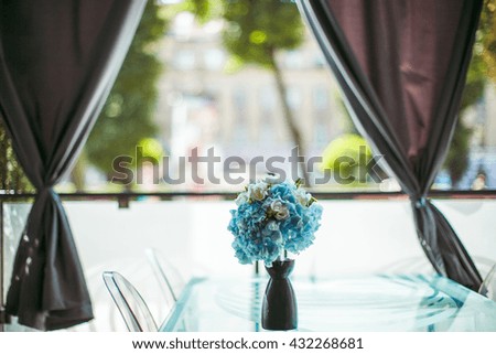 original  bouquet of white and blue flowers stands on a table