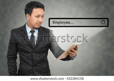 Asian businessman using the tablet with browsing of Internet searching "Employee" bar on the wall background, Internet concept