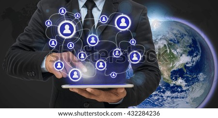 Businessman using the tablet for social connection on world map and earth background, Elements of this image furnished by NASA, Business network concept
