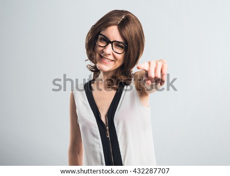 Brunette woman pointing to the front